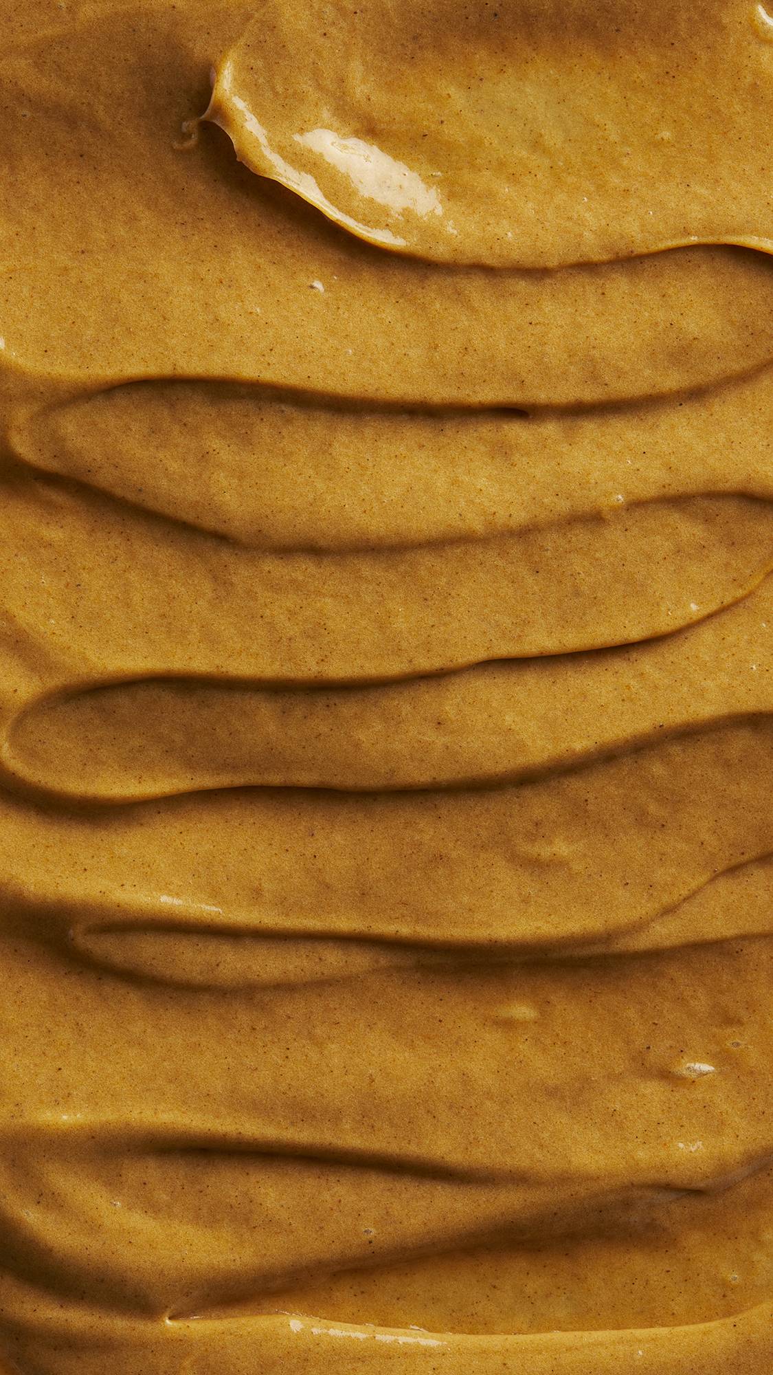 Image is a very defined close-up of the thick, batter-like golden-brown hot oil treatment spread over the screen.