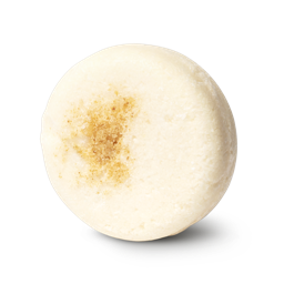 Honey I Washed My Hair. A cream coloured, circular solid shampoo bar, with honeycomb pressed into the top.