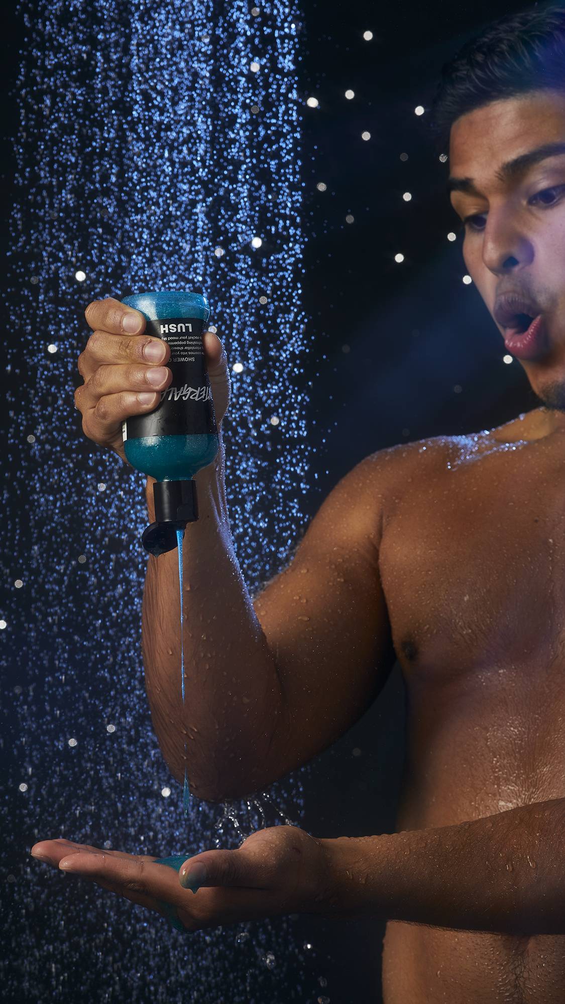 Image shows the model in the shower squeezing the Intergalactic shower gel into their hand with an impressed face.
