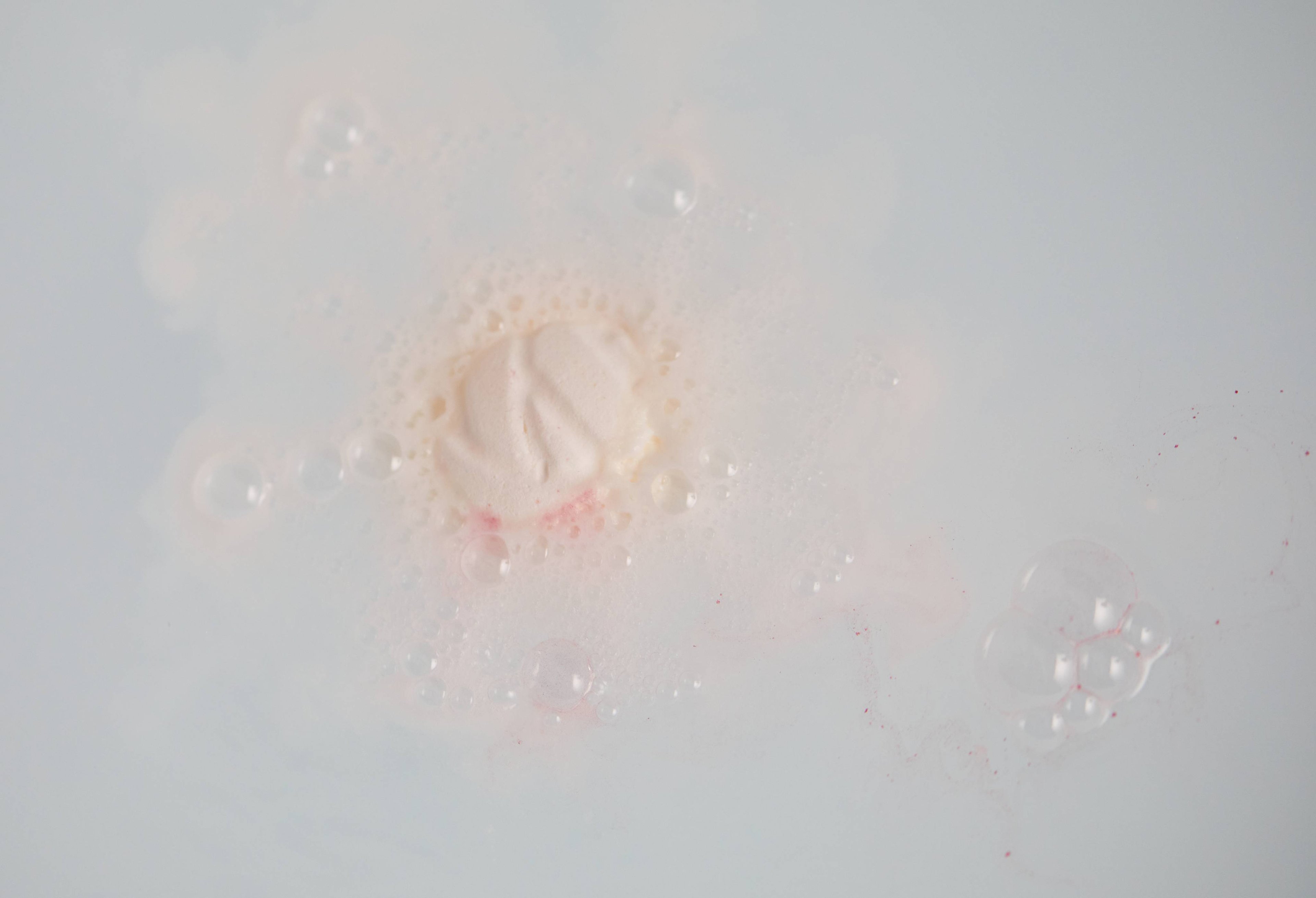Bath bomb slowly dissolves in the bathwater creating subtle, creamy swirls of velvety water. 
