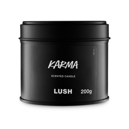 Karma. A round, black, candle tin with a removable lid. The black label on the front reads "Karma Scented Candle" in white text.