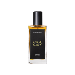 A glass perfume bottle filled with dark amber liquid. A black label reads 'The Perfume Library' and 'Keep It Fluffy'.