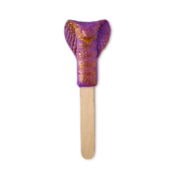 King Cobra. A playful, reusable bubble bar comprised of a wooden stick handle and topped with a bubble bar shaped like the splayed face of a hissing King Cobra snake. It is a deep purple colour with a golden lustre coating the product. 