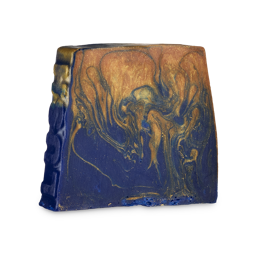 Lailah. An off-square soap slice with the word "LUSH" embossed on the left-hand side. The soap is a deep, midnight-blue colour with swirling, marbled, glittering gold from the top. 