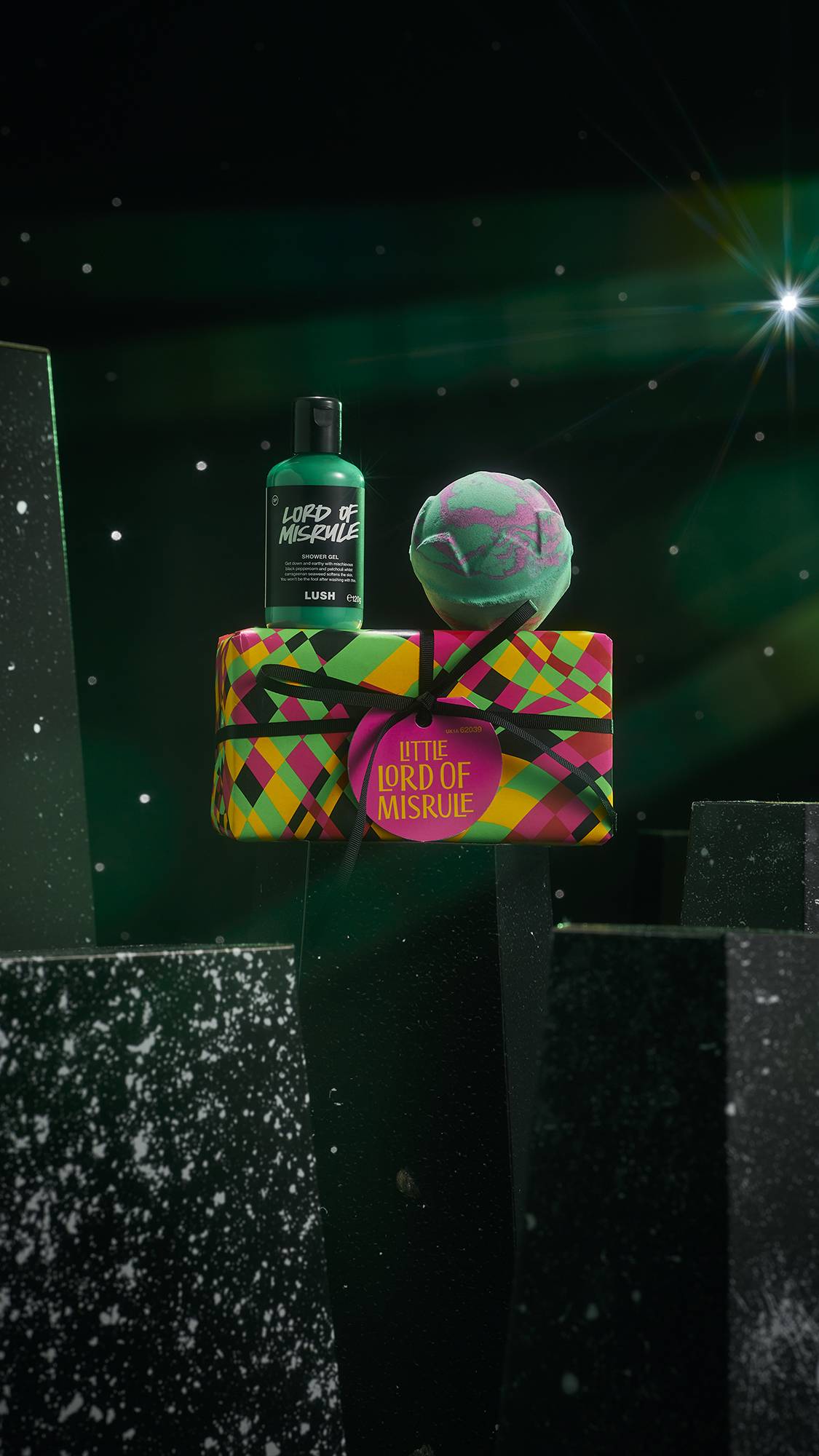 Little Lord of Misrule gift. A groovy, neon-wrapped box with black string sat under a Lord of Misrule shower gel and bath bomb.