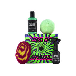 A Lush Lord of Misrule gift featuring a green shower gel, green bath bomb, burgundy swirl bubble bar, and black body spray bottle placed around a psychedelic green and purple box.
