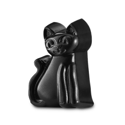 A solid, matte black Lush Lucky Cat facial gummy against a white background. The stylized feline figurine features large carved eyes, a small smiling mouth, pointed ears and a curved tail along its side