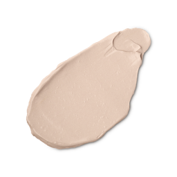A close-up product swatch of a thick, elongated, textured streak of Luminator - skin tint. The color is a pale, creamy rosy-beige