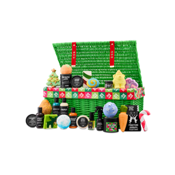An open green wicker hamper with red straps overflows with festive Lush products, including bath bombs, shower gels and body lotions, with some shaped as Christmas favourites.