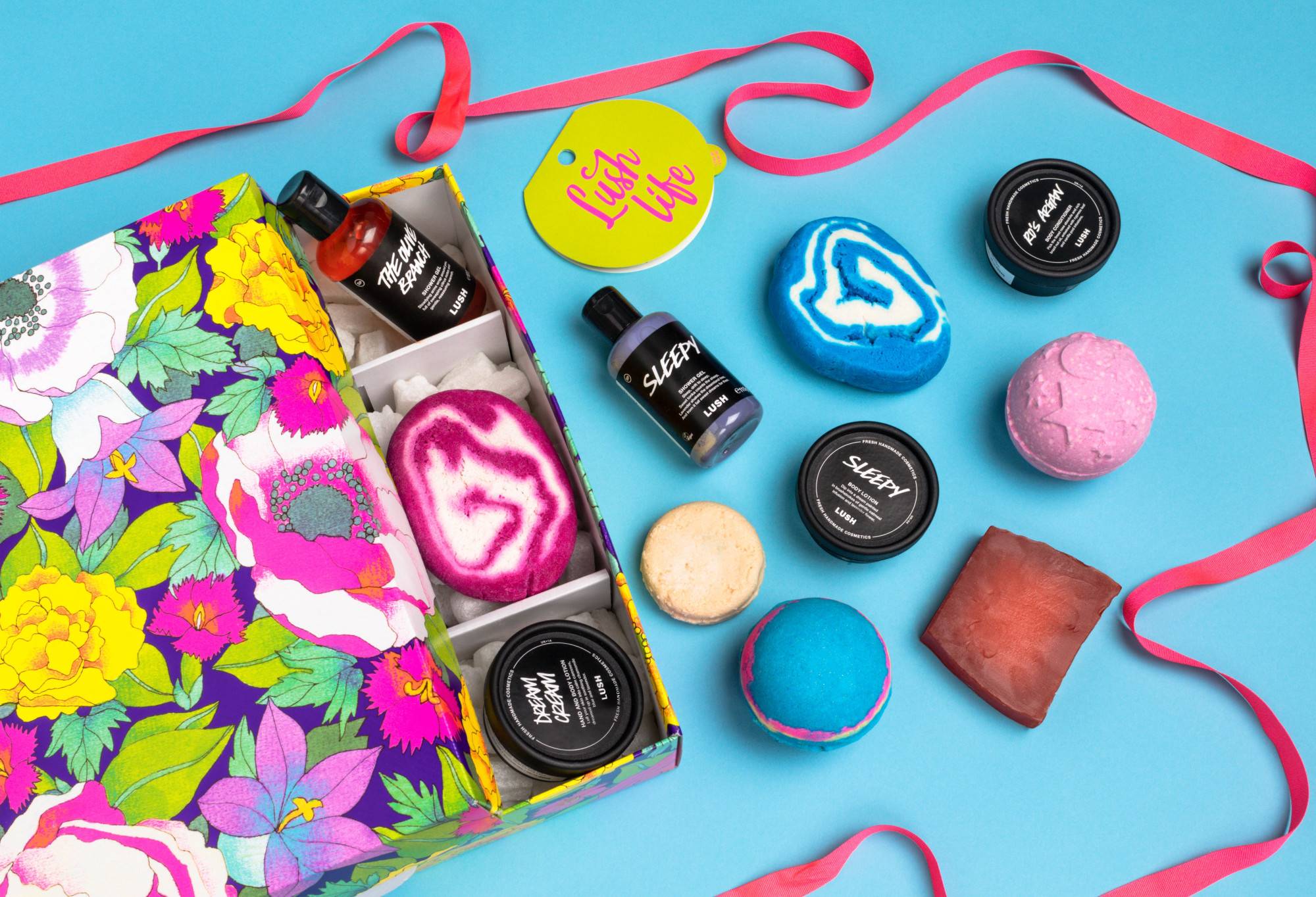 Lush Life, partly opened onto a light blue background, with its abundance of products and eco packaging pops being displayed.