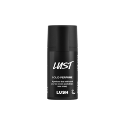 Lust. A short, cylindrical black push-up tube of the Lust solid perfume with a black label on the front covering the cap, with the product name and scent printed on it. 