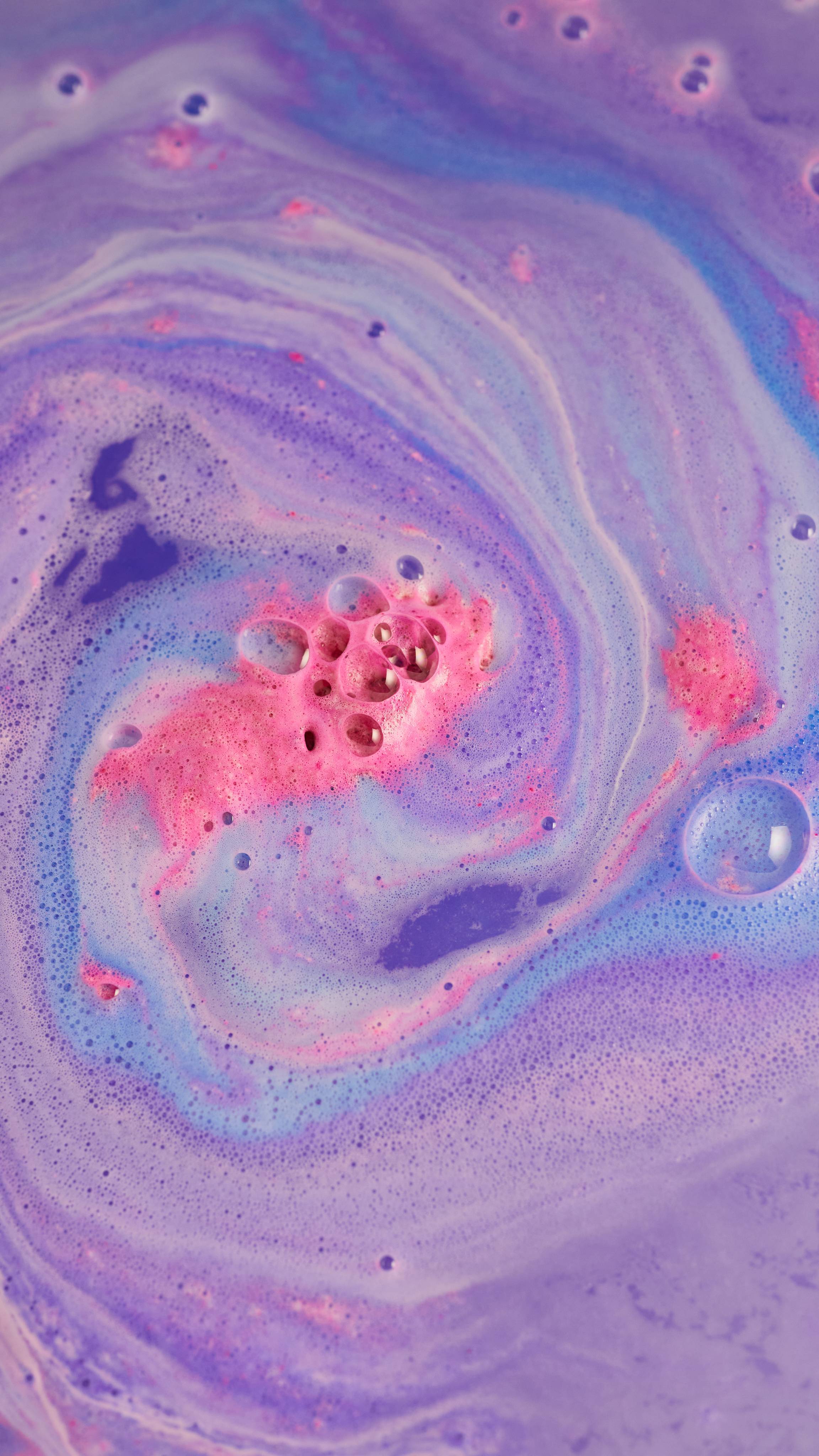 The bath bombs has completely dissolved leaving a think, velvety blanket of pink, purple and blue swirls.