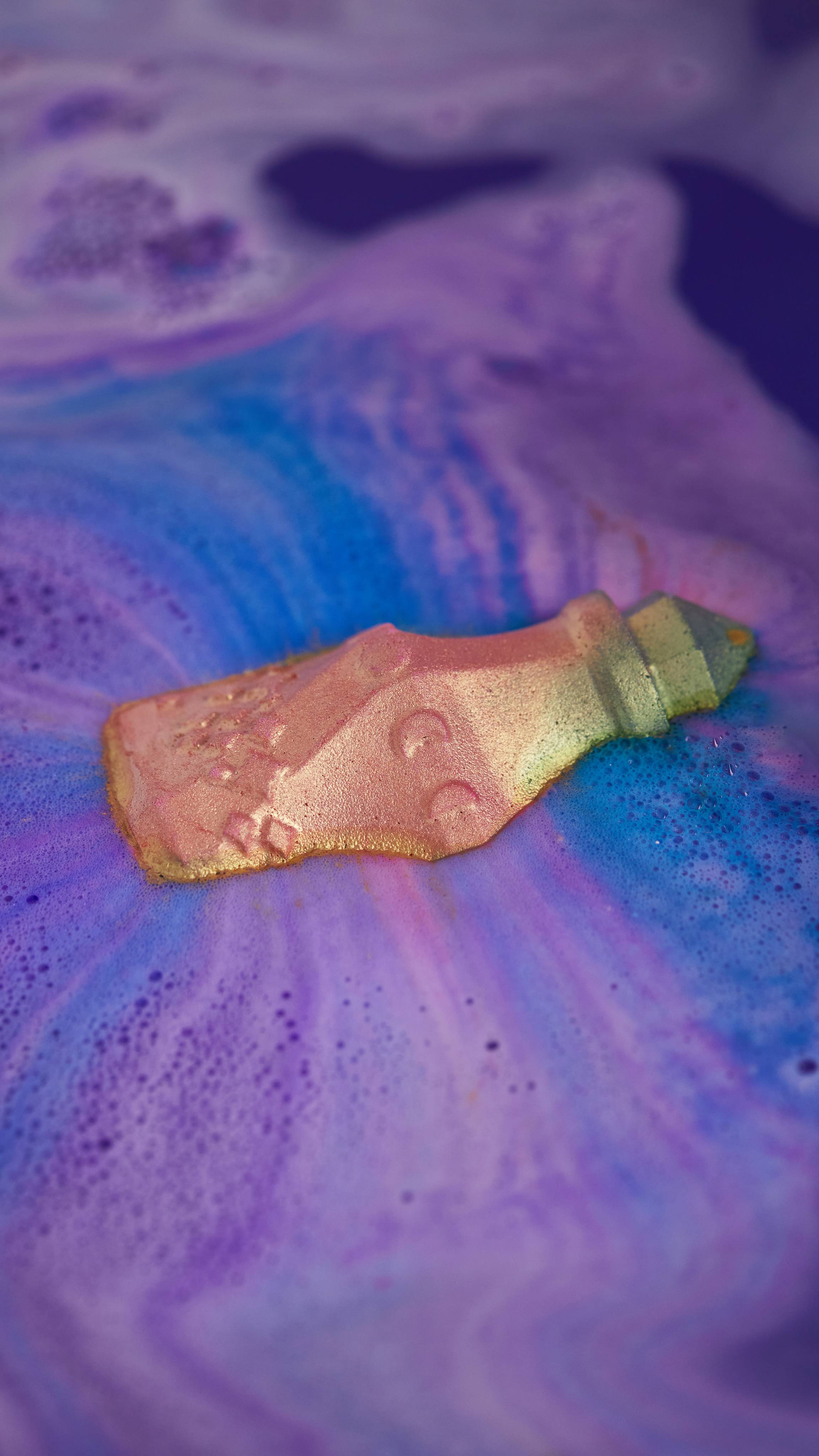 Magic Potion bath bomb dissolves its shimmer revealing enchanting swirls of deep pinks, blues and purples. 