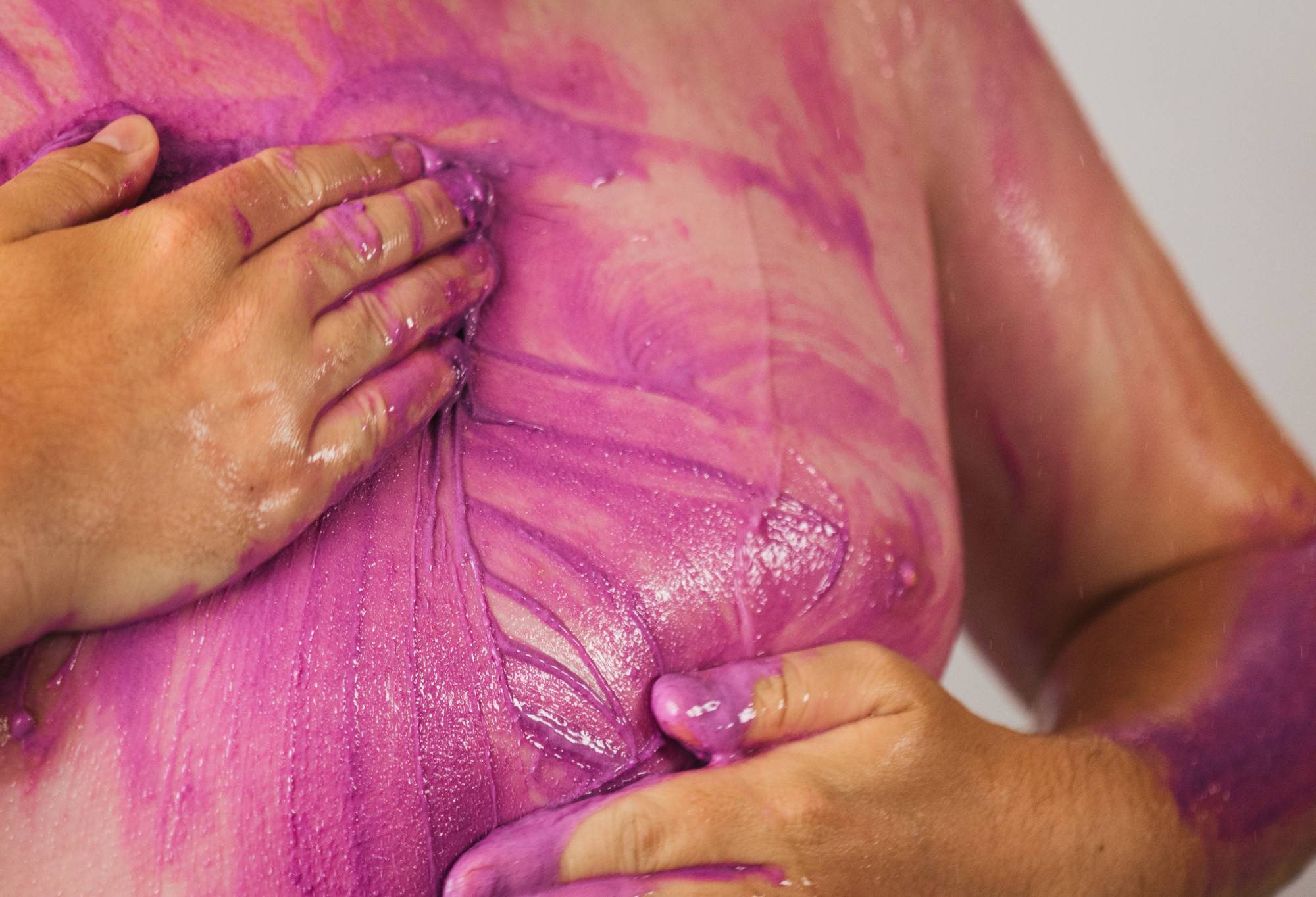 Magic Crystals, a vibrant purple, thick body scrub, is massaged over the chest and pecks.
