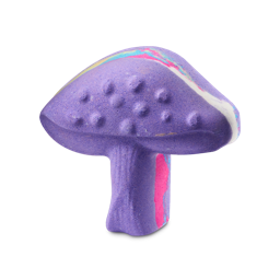 Magik Mushroom. A vibrant purple bath bomb shaped like a mushroom. The cap features small raised bumps and a swirled band of pink, blue, yellow, and white that runs all the way around the middle of the product. 
