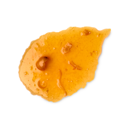 Marmalade body wash. A smudged swatch of thick, translucent orange body wash, resembling marmalade, with visible pieces of fruit zest and pulp. The texture is glossy and slightly bubbly, shown as a single smear.