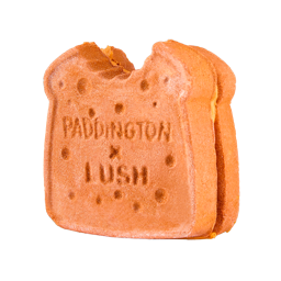 Marmalade Sandwich. A brown, sandwich-shaped bubbleroon bubble bar with a small bite taken out of the top corner. The textured surface features the embossed text ‘PADDINGTON x LUSH’ and bread texture detail.