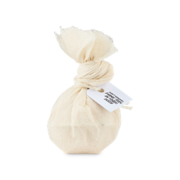 Moisturising Coconut And Mullein Cataplasm. A white, spherical bath bomb wrapped in muslin fabric, tied with a knot and white string and product tag which reads "Don't unwrap, dunk this in your bath"
