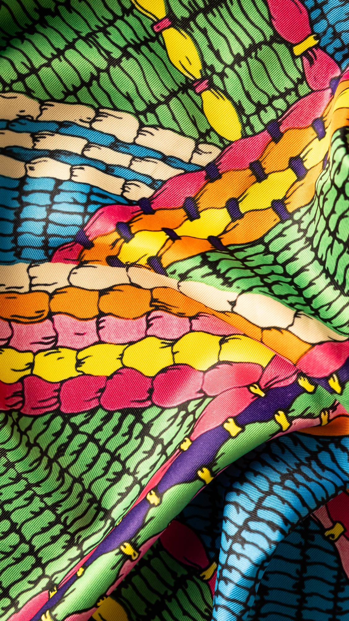 Image shows a super close-up of the Neon Weave knot wrap focusing on the intricate details in the weave style illustration.