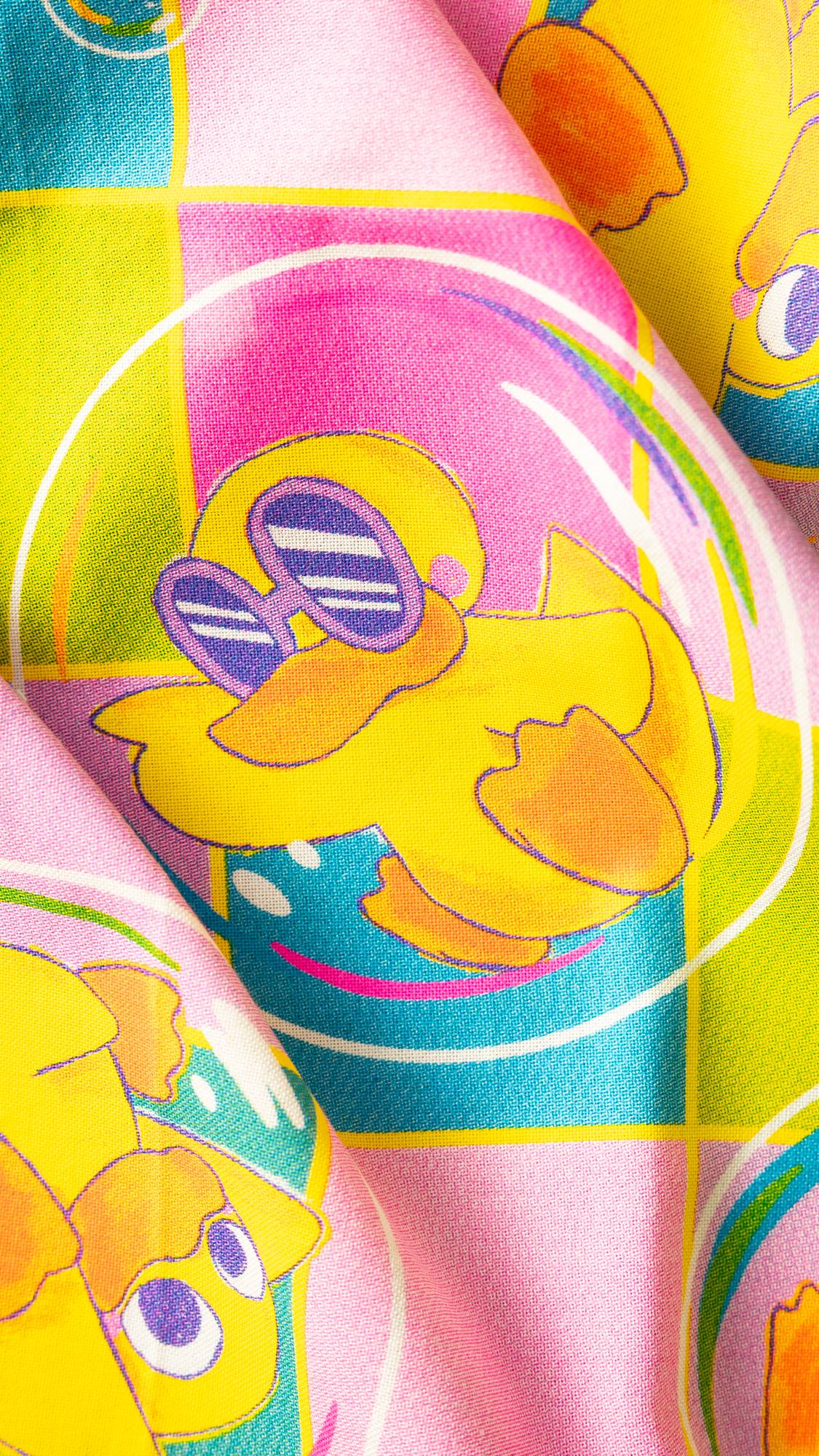 Image shows a super close-up of Nice Bath Time for Ducks knot wrap focusing on a fun, yellow duck in funky sunglasses. 
