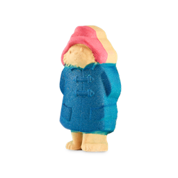 Paddington. A detailed bath bomb shaped like Paddington Bear, wearing his iconic red hat and blue raincoat. The character is standing upright and features a slight glitter in the blue coat.