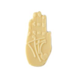 Palm Reader naked hand cream. A pale cream, solid product shaped like an open human hand, palm facing forward. It features intricate embossed palmistry lines and a small heart symbol.