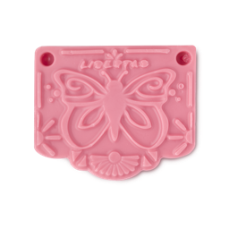 Papel Picado Rosa soap. The image shows a smooth, vibrant pink rectangular soap. Its surface features an embossed butterfly, sun rays, and the word 'LIBERTAD', all in a stylised, decorative design resembling a bunting flag.