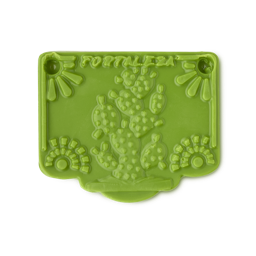 Papel Picado Verde soap. The image shows a smooth, vibrant green rectangular soap. Its surface features an embossed cactus, suns, and the word 'FORTALEZA', all in a stylised, decorative design resembling a bunting flag.