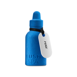 Peace. A vibrant blue bath bomb shaped like a dropper bottle. The words 'LUSH SPA' are embossed at the base, and a white tag with the word 'PEACE' is tied around the neck with a black ribbon.