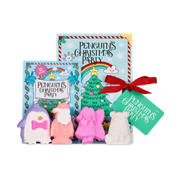 Penguin's Christmas Party. A gift box designed like a children's book with a striped border and a large Christmas tree with a rainbow overhead. There is a matching story booklet standing beside the box and four Christmas bath bombs in front. 