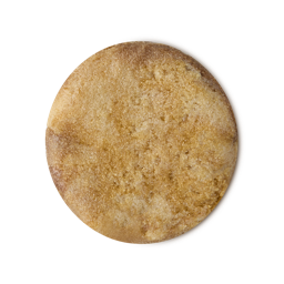 Posh White Chocolate and Rose. A circular swatch of caramel and ivory textured sugar-based body scrub. 