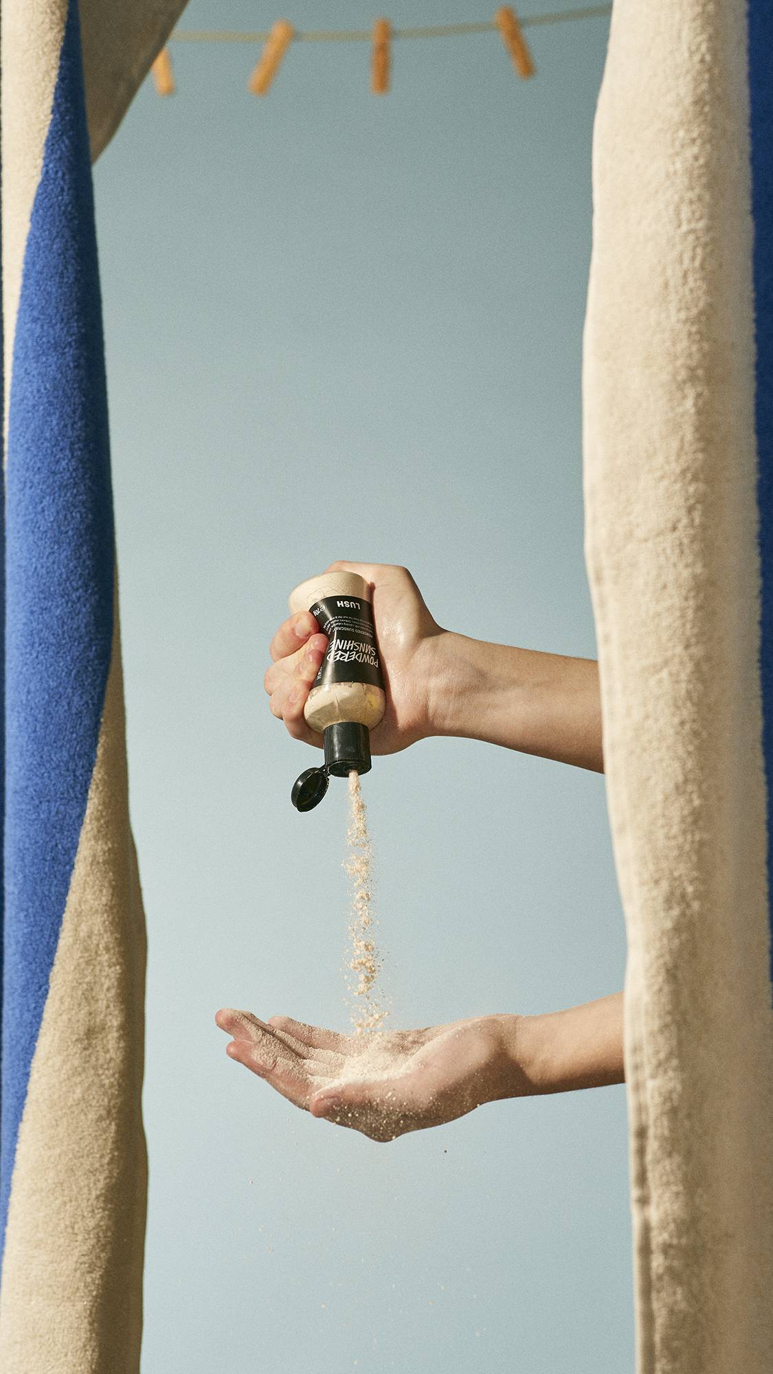 Image shows models hands as they hold the product bottle, squeezing the powder into their other hand below.