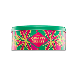 A cylindrical Lush gift tin with a pink and teal geometric diamond pattern outlined in green, featuring a central pink label with gold text reading "Quality Treats"