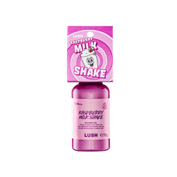 A bottle filled with bright pink Lush shower gel, topped with a retro pink cardboard tag illustrated with a cartoon milkshake character and the text "Raspberry Milkshake"