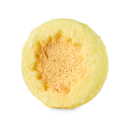Ray of Hope. The image shows a round, pale yellow solid shampoo bar. Its outer surface is covered in shredded coconut, with a central, rough sun-shaped hollow filled with golden lustre.