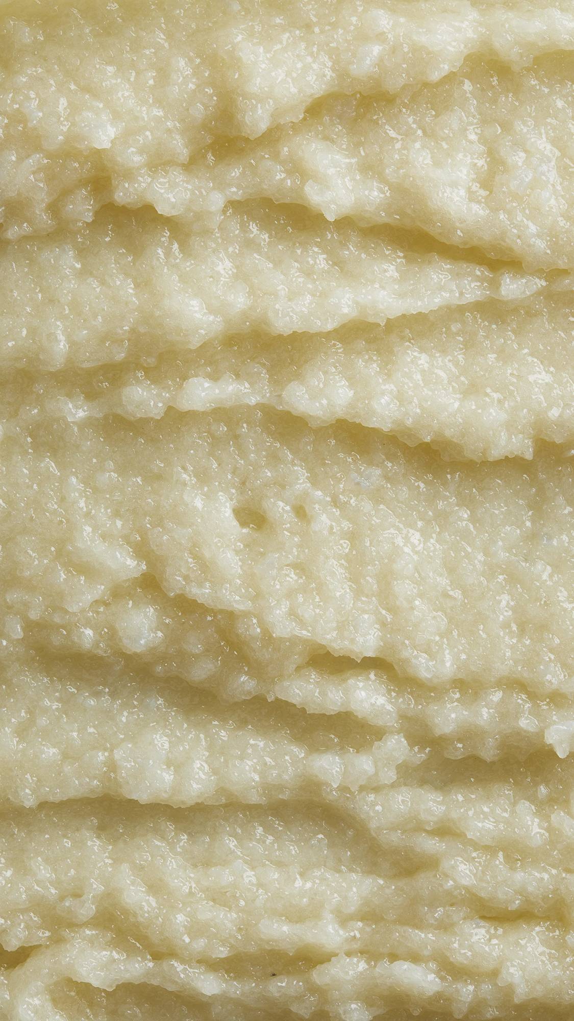 Image is a very defined close-up of the thick, exfoliating shampoo showing almost batter-like folds.