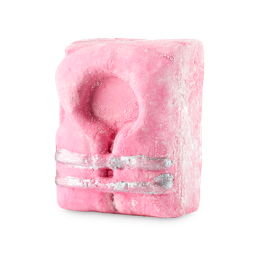 A bright pink, rectangular bar of solid body wash shaped like a life vest. It features a molded collar and two shimmering silver straps across the front, set against a transparent background