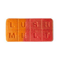 Roasting Chestnuts. A rectangular wax melt in a vibrant, sparkly orange and red gradient colour with 8, equal segments spelling out "LUSH MELT"