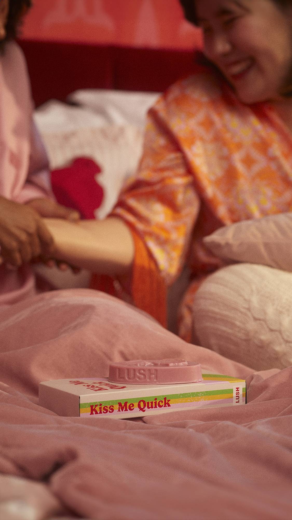 Image is focused on the Rose Argan massage bare in the foreground as it sits on a retro VHS tape box.
