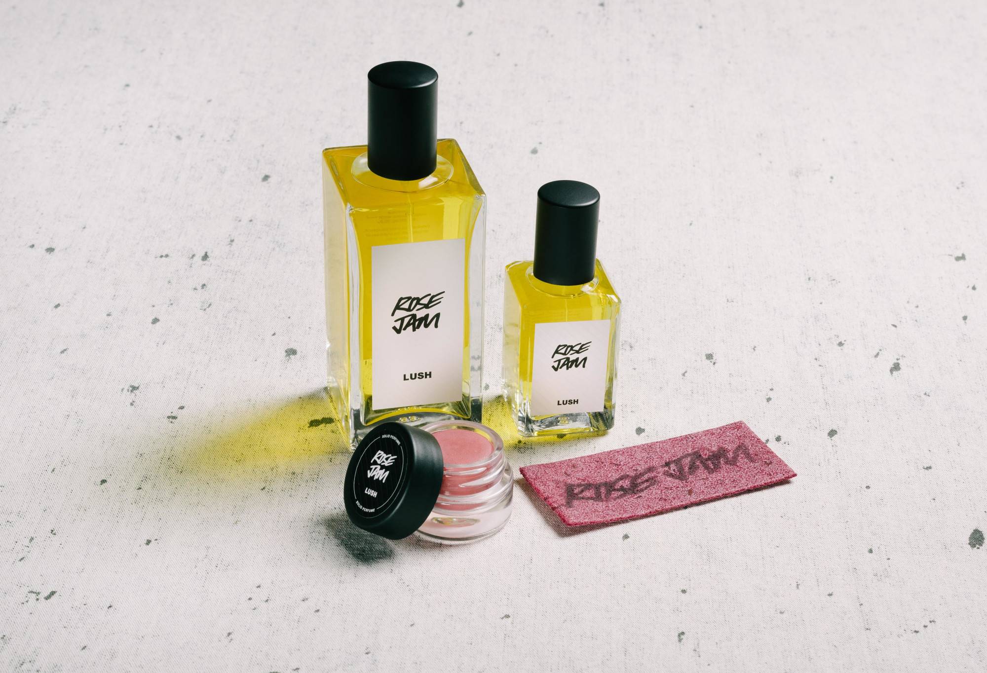 The whole Rose Jam fragrance collection (bar body spray) is displayed on a white surface, flecked with grey.