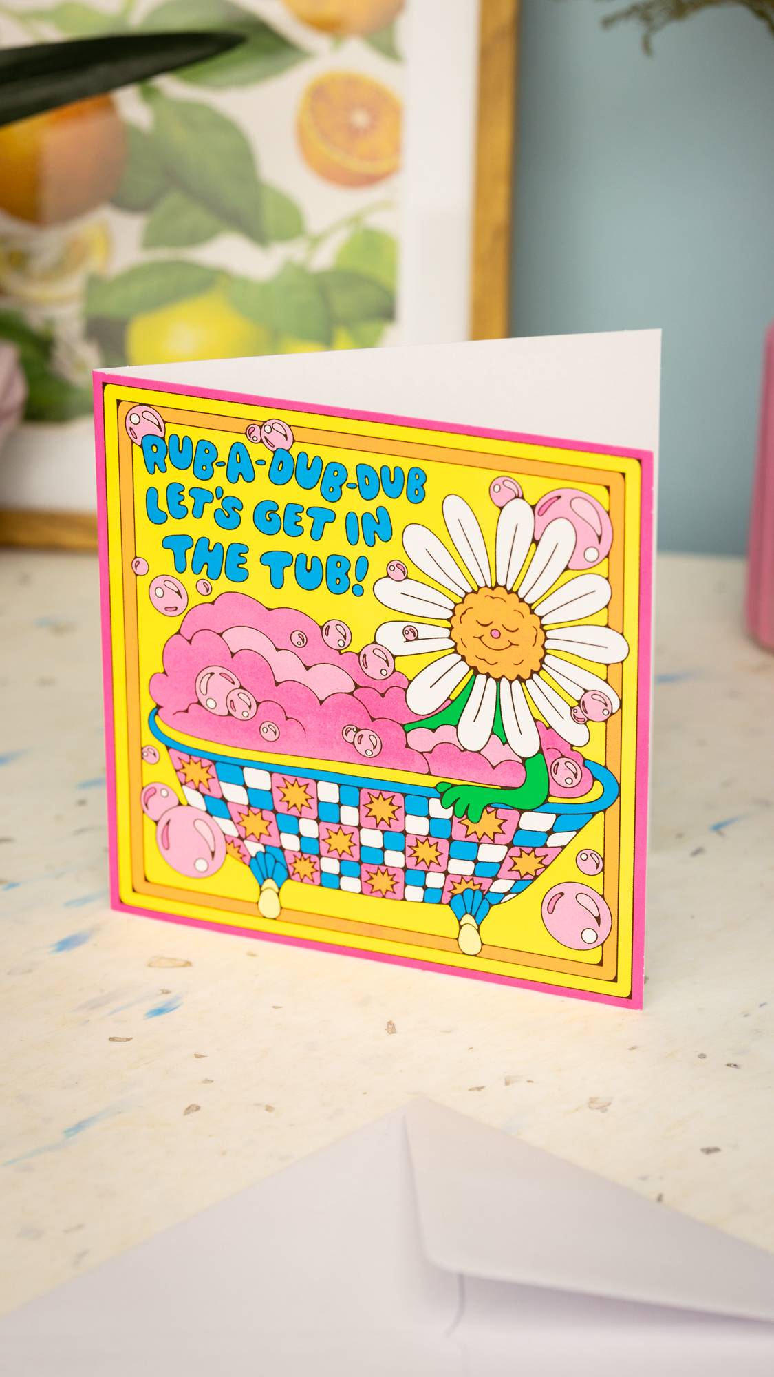 Image shows the Rub-A-Dub-Dub Let's Get In The Tub greetings card stood on a table, having just been opened.