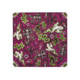 A square sheet of Lokta wrapping paper featuring a busy, jagged magenta and black background. It is decorated with a repeating comic-style Halloween pattern of dancing white skeletons, cartoon ghosts, black cats, and green 'BOO!' text.