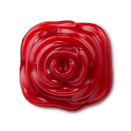 Sexy shower gummy. A vibrant red, blooming rose-shaped product is sculpted with a glossy, spiral petal pattern in the centre. The smooth gummy soap features a subtle, shimmering glitter throughout.