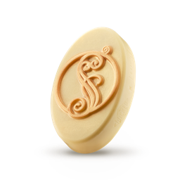 Shiz University. A thick, oval slice of creamy, solid massage oil. The Wicked X LUSH logo is embossed on the side and the top is decorated with a golden, shimmering, swirling "S" character.