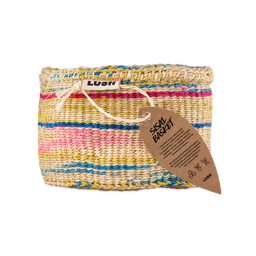 A handwoven Lush colourful sisal basket featuring stripes of yellow, pink, blue, and natural fibres, complete with a leaf-shaped craft tag