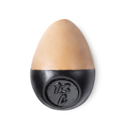 Slap Stick 13C. A medium light-cool, warm, rosy-beige coloured, egg-shaped solid foundation, with a black wax base.