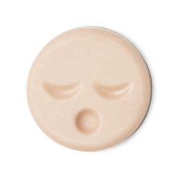 Sleepy Face. A circular, pale peachy pink naked cleansing balm, engraved with little yawning face.