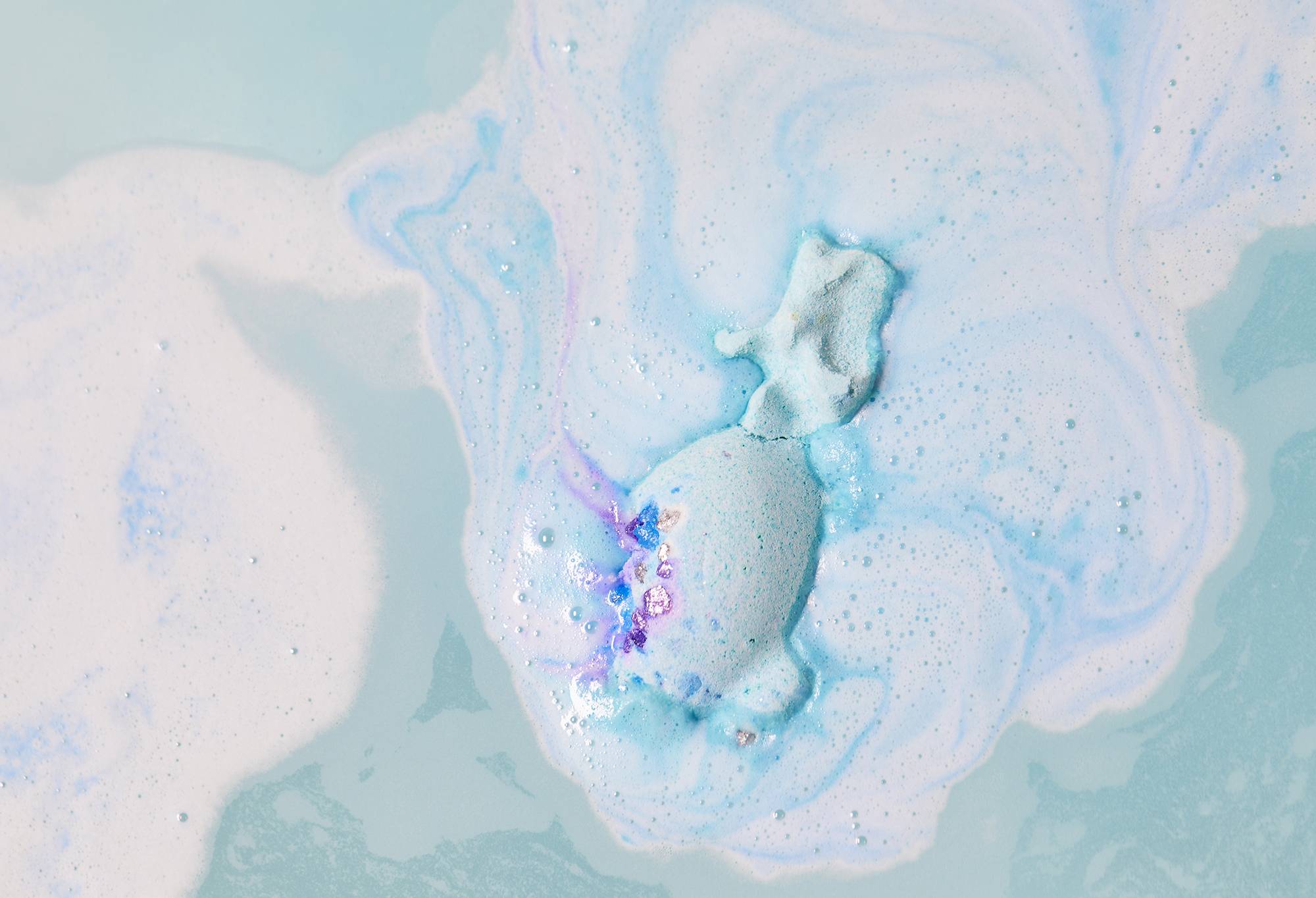Snow Dragon bath bomb has almost fully dissolved leaving streaming swirls of blue and tiny twirls of purple.