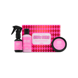 A Lush 'Snow Fairy Body Care Discovery Set' box featuring pink diamond patterns, displayed with a body spray bottle, Snow Fairy Milkshake shower gel bottle, and a tub of body lotion,