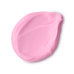 A studio shot of a textured swatch of LUSH Snow Fairy body lotion, a thick and creamy pink product, against a light gray background.
